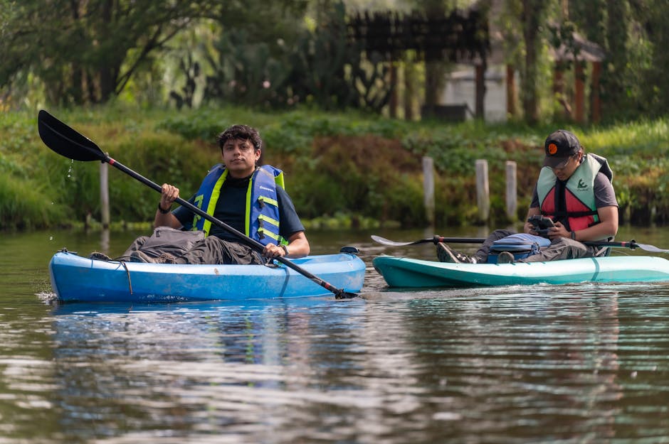 Two men kayaking on a calm river in CDMX, Mexico, enjoying a sunny day outdoors.