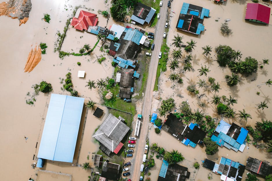 Drone view of a residential area in Kijal, Malaysia, showing extensive flooding and submerged buildings.