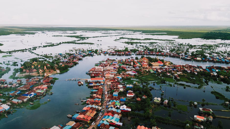 Stunning aerial view of Kampong Khleang floating village in Siem Reap, Cambodia, showcasing traditional stilt houses on water.
